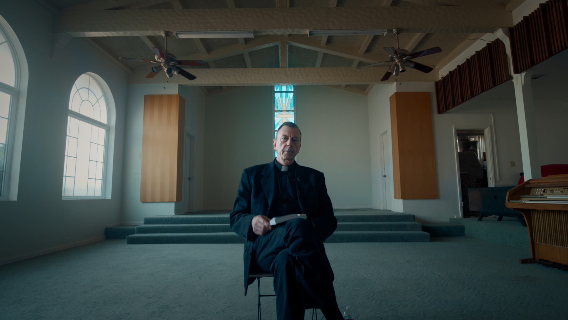 a still of a priest from the film Christpiracy